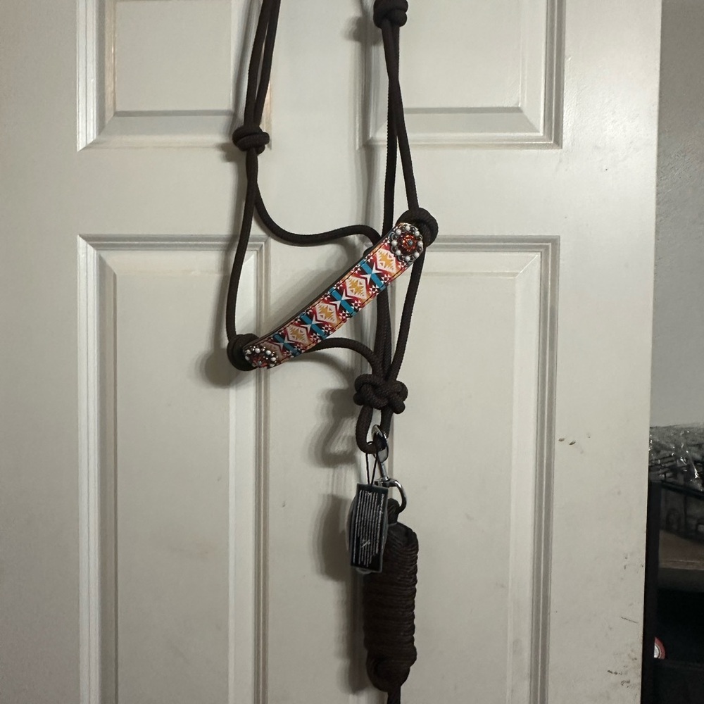 Tacktical rope halter with leather nose piece and conchos.